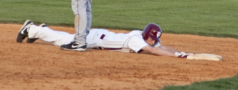 Justin Hurst, sophomore infielder, slides back to safety after trying to steal a base against Trevecca Nazarene University on April 6. The Grenadiers came back from a 5-0 deficit by scoring 10 runs in the bottom of the seventh inning to win 15-6. 