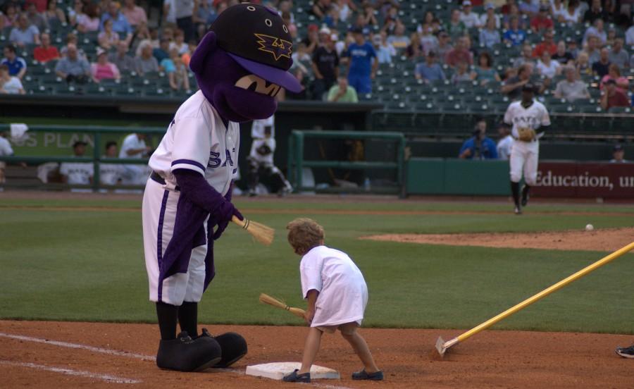 Buddy the Bat got some help from a game attendee to help clean off the bases between innings. The game between the Louisville Bats and the Pawtucket Red Sox marked the annual IUS Night at the Bats.