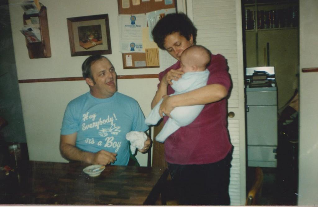 My mom and dad hold me on my first day home from the hospital. 