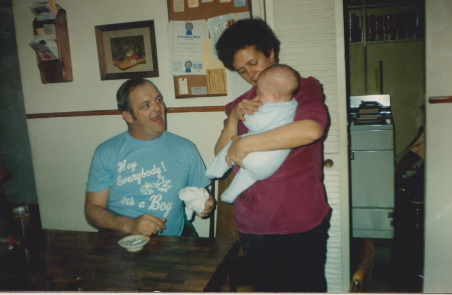 My mom and dad hold me on my first day home from the hospital. 