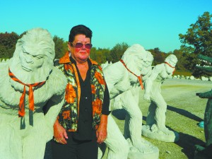 Peggy Woods, also known as the Concrete Lady, surrounded by her current bestselling item, Bigfoot. 