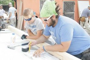 Dietrich goes over the building plans for a home in Juarez, Mexico with another volunteer.