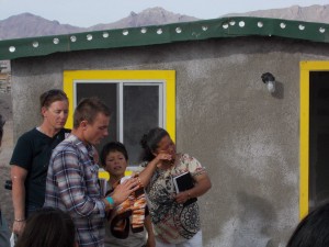 A woman cries at the dedication ceremony of her new home in Juarez, Mexico.