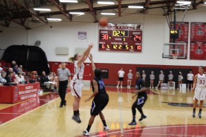  Wheat drains a three-pointer just before the first half buzzer sounds to put the Lady Grenadiers up 41-24.