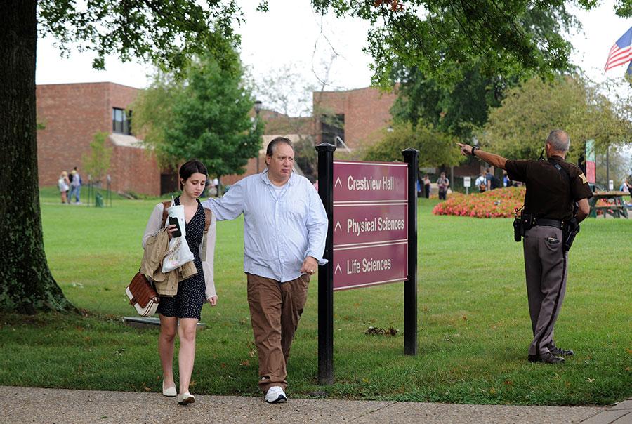 Greg Ezell, Jeffersonville, walks his daughter, Kymber, to their vehicle in the Indiana University Southeast parking lot following a lock-down stemming from reports of an armed gunman on campus. The false alarm was triggered after a student reported seeing what looked to be a gun handle sticking out of a camouflage backpack. Emergency responders arrived on campus around 1 p.m. where they identified the object as a large umbrella and the issue was then resolved. 
