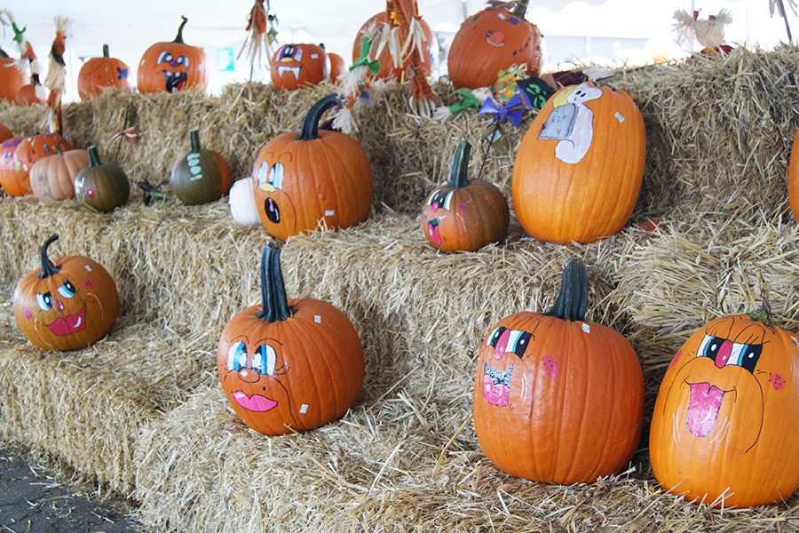 Huber’s employees paint decorative faces on pumpkins to sell to the public.
