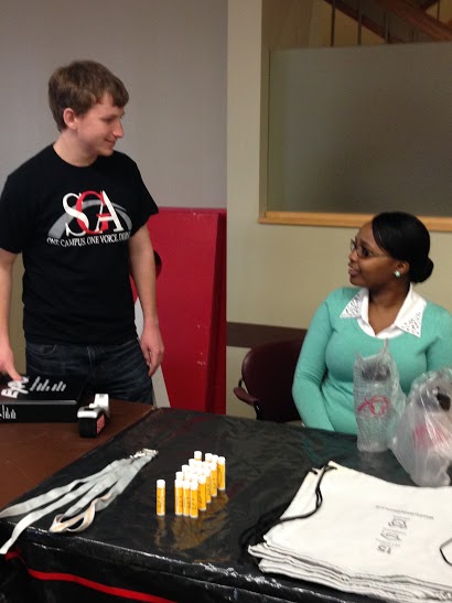 Trent Wallace, SGA president and advertising and communications junior, speaks with Angel Russell, SGA chief justice and sociology junior during the SGA homecoming event on Wednesday, Feb. 11