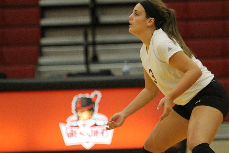 Maddie Jacobi, freshman defensive specialist, gets ready for a serve in Thursdays game against Spalding University. The Grenadiers beat the Golden Eagles in their home opener .