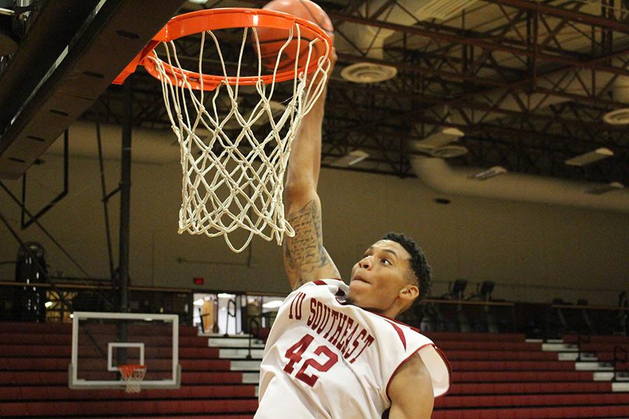 Jordan Thompson, senior forward, dunking the ball in the Activities Building. Thompson is also pitching for the IUS men's baseball team during his senior year.