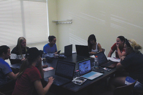 Some players from the IUS softball team gather around a study table in the the library. Outfielder Montanah Rogers, biology sophomore, said that the softball team is required to go to study tables for at least two hours, two days a week.