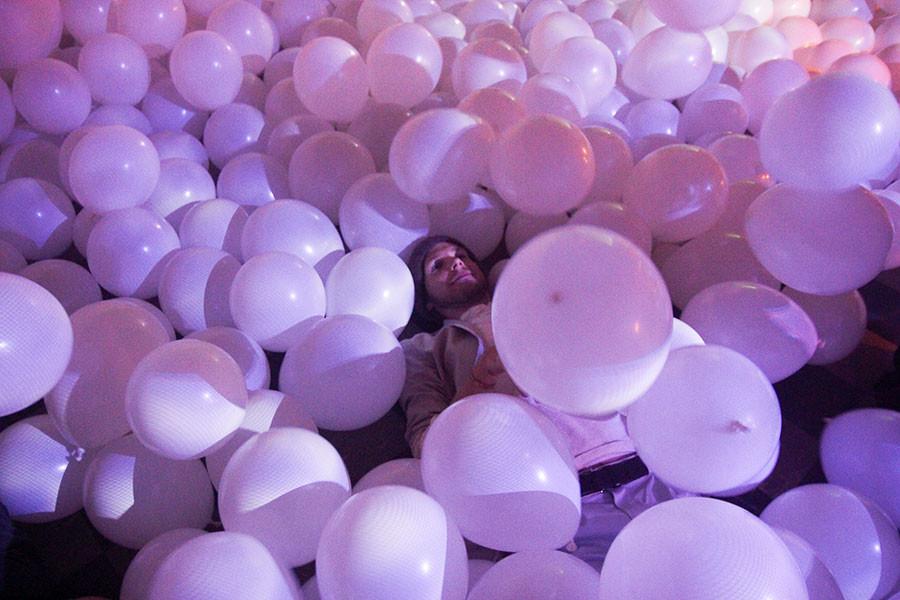 Christian Bowyer, communications and theatre senior, playing in the balloons. There were 1,800 balloons at the Balloonacy event. 