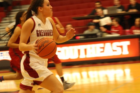Junior forward Michaela Harris pushes the ball on a Grenadier fast break.