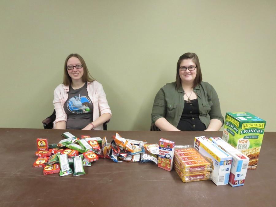 Aimee Kelmel, sociology senior, and Aubrey Garman, psychology and sociology senior, collect individually wrapped snacks Thursday, Jan. 14 in The Commons for the Sociology Club. The snacks will be added to care packages that will be distributed to the homeless during the Point in Time count on Wednesday, Jan. 27. 