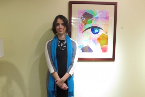 Reba Potter, fine arts senior, stands next to a piece from her B.A. senior art exhibition on Thursday, Jan. 14.
