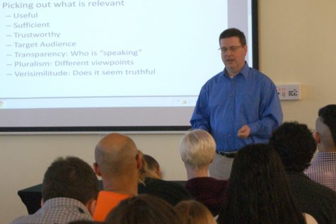 Ron Allman, professor of journalism, speaks to the crowd about the media and if they need to change the way they cover politics.
