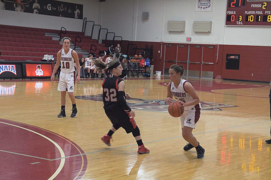 enior guard and transfer from UC - Clermont, Katie Slavey attacks the basket. Slavey played her last three years as a Grenadier. Photo by Parker Henes