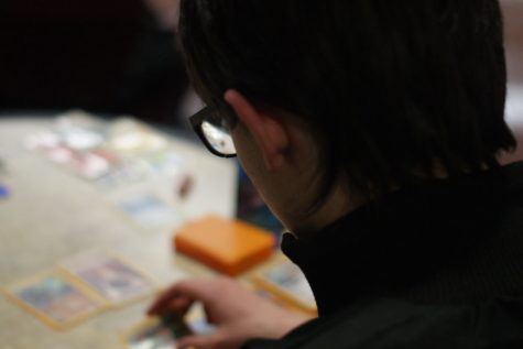 Myles Bond, non-student, plays the “Pokemon Trading Card Game” with friends. Bond said the event has become more open to non-students.