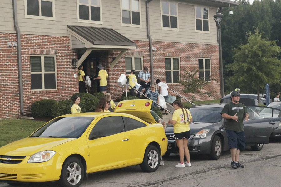 Volunteers help with campus move-in day.