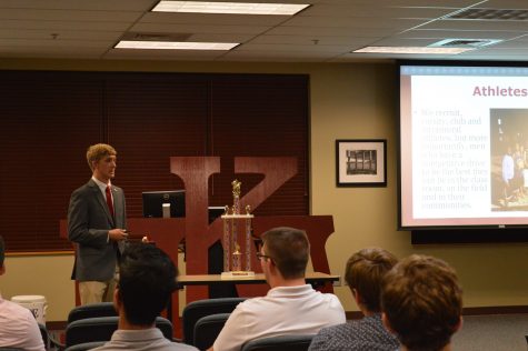 Dakota Brooks, education sophomore, discusses with potential members what Pi Kappa Alpha looks for when recruiting new members.