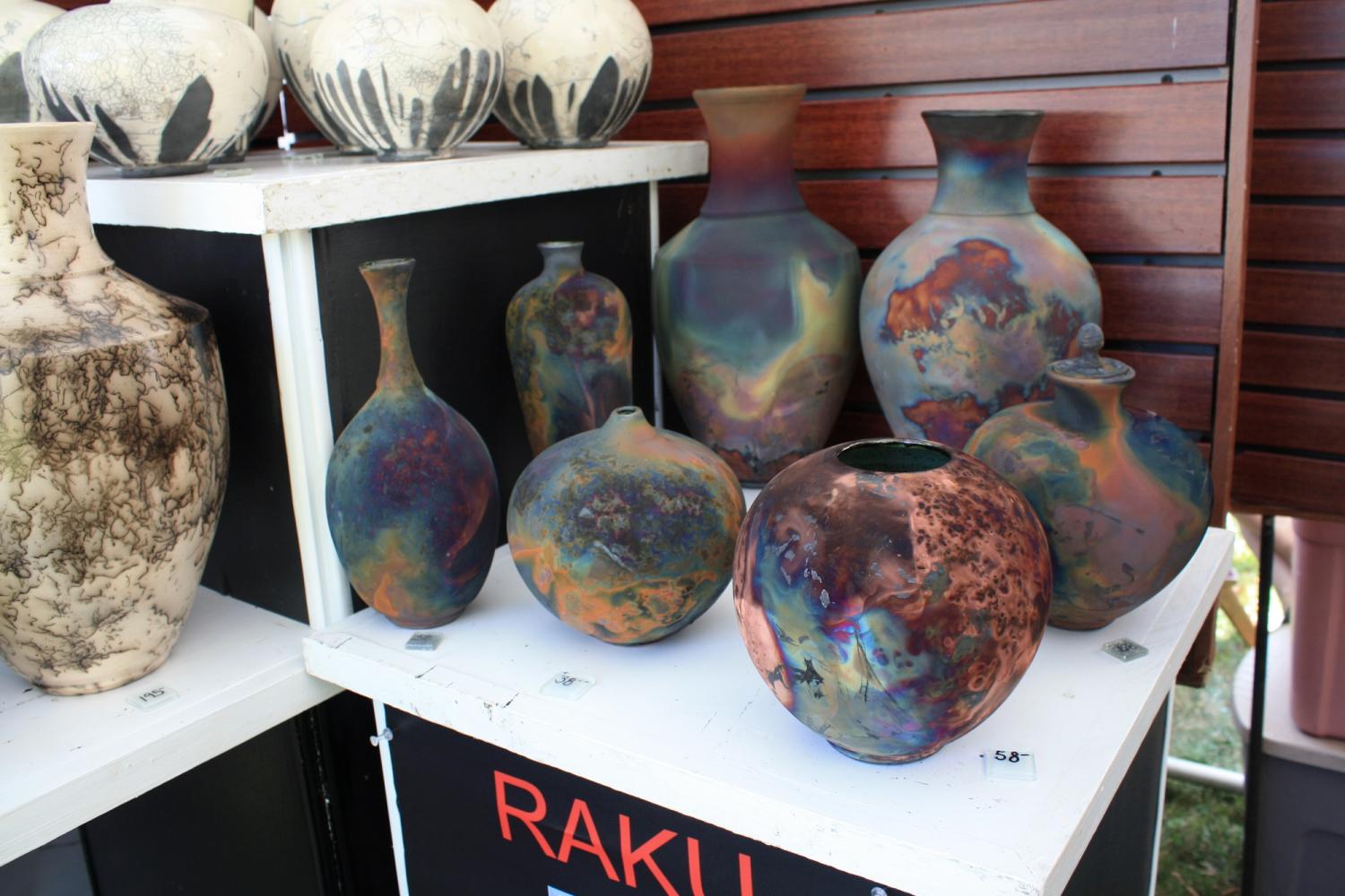 Raku pottery by Philpot, KY artist Thomas Porter. Thomas work is influenced by his early trips to Japan, China and Korea, where he first learned about Raku, a technique where clay is glazed, fired in a kiln at a lower temperature than usual and then cooled very quickly in either combustible materials or water leaving the pieces with rich velvet shades and the signature crackle. Porter said this technique was currently his favorite as well as his most popularly bought pieces.
