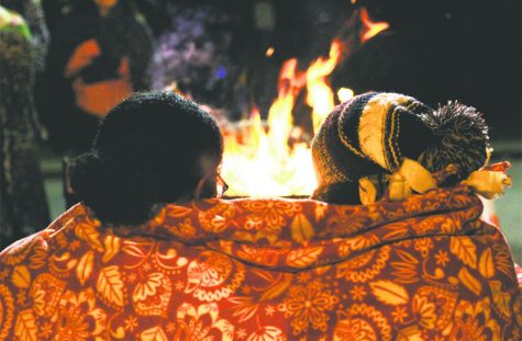 Sophomores Tessa Duncan and Katie Shircliff snuggle up by the fire to keep warm on the chilly November night.