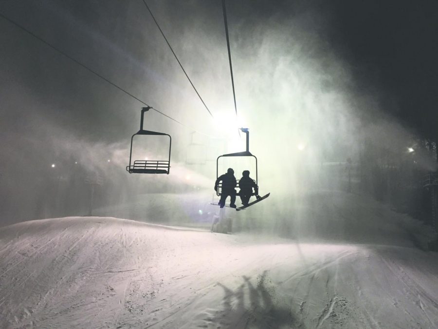 Skiers ascend the lift at a night at Paoli Peeks.