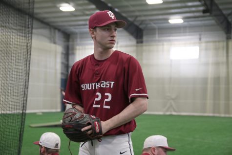 John Cecil, senior right-handed pitcher, warms up from the stretch at practice.