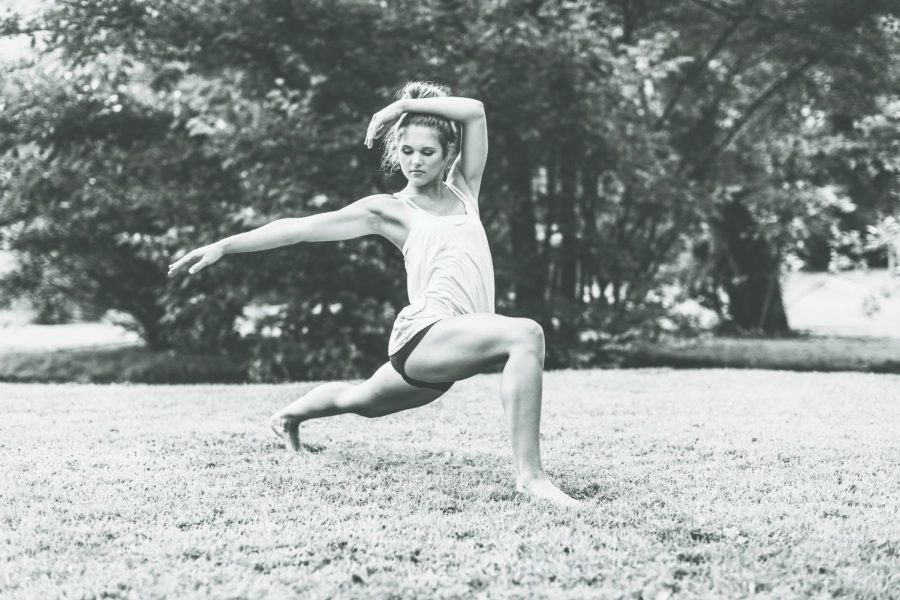 Audrey Schlegel, biology junior at IU Southeast, practicing yoga in her front yard. Her favorite part about yoga is that it brings awareness to her body and mind. Photo by Courtney Sinclaire.