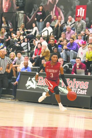 Jamie Johnson slams a dunk against Asbury University. Below, Johnson brings the ball up the court against IU East.