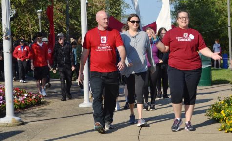 Students, faculty and community members walk in the Out of the Darkness walk to prevent suicide.