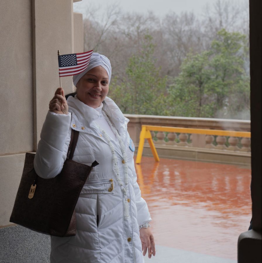 Cuban refugee Arianna Martinez waves an american flag to show support. Small american and Kentucky state flags were passed around to anyone that wanted tone.