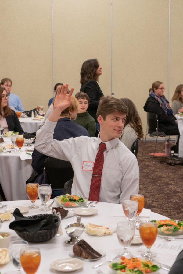 Jay Rice, junior, raises his hand to answer a question posed by Starvaggi. Attendees were encouraged to get involved in the lecture.
