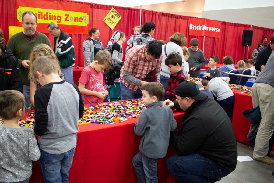 Children and guardians gather at the Lego Building Zone to create projects of their own.