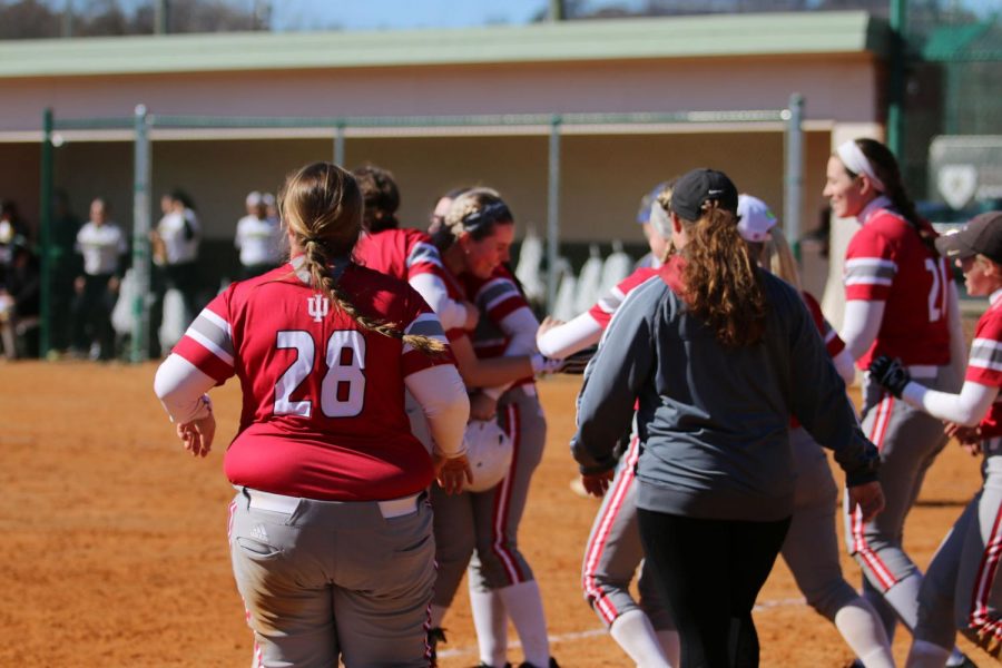 Sydney Seger gets mobbed by teammates after delivering a walkoff RBI single in the ninth inning of game two of a doubleheader versus Point Park University.