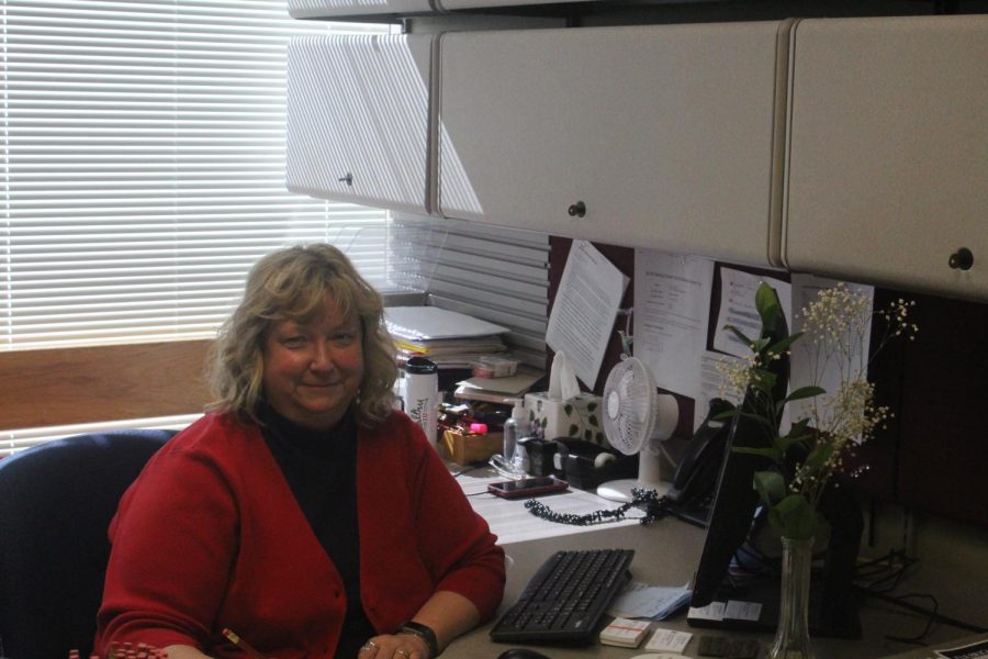 Kim Robertson poses at her desk in the Graduate Studies and Research office in the University Center. Photo by Tessa Arnold.