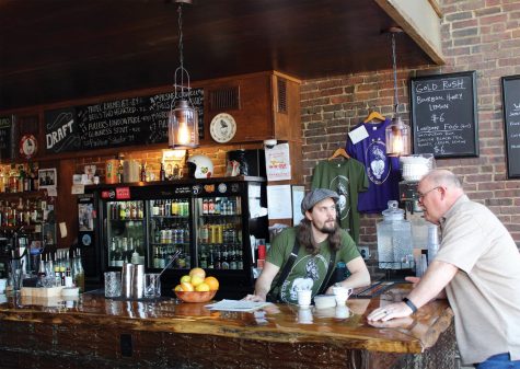 A curious patron, asks the bartender what he has on tap. Pints&union serves a plethora of classic cocktails and comfort beers. Photo by Bryce Shreve.