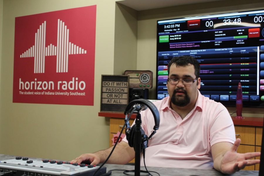 Station Manager Matt McClellan mans the sound board inside Horizon Radio’s broadcast room.  McClellan has led the station for three semesters. “I enjoy hearing stories and talking to people and hearing what they have to say or play,” he said.