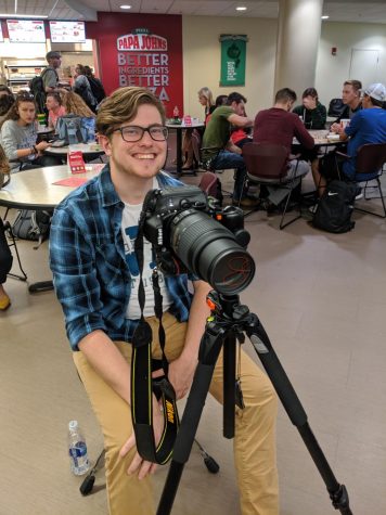 PRSSA Vice President Josh Roy mans the camera at a professional head-shot event the club held this semester.