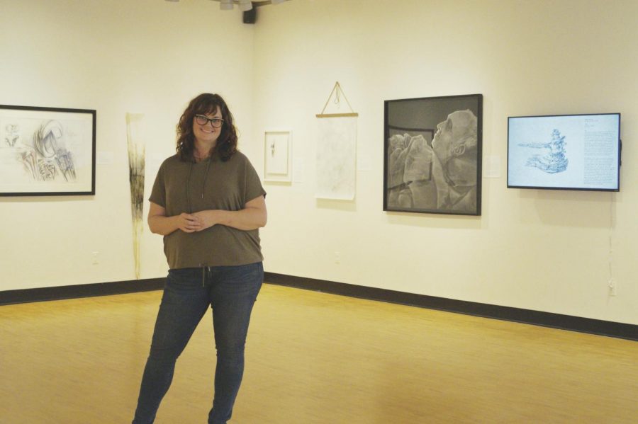 Emily Sheehan, assistant professor of fine arts, stands in the Barr Gallery.