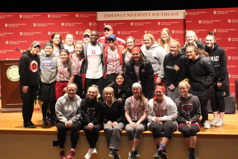 Chris Singleton poses for a picture with the IUS Softball team after the conclusion of the event.