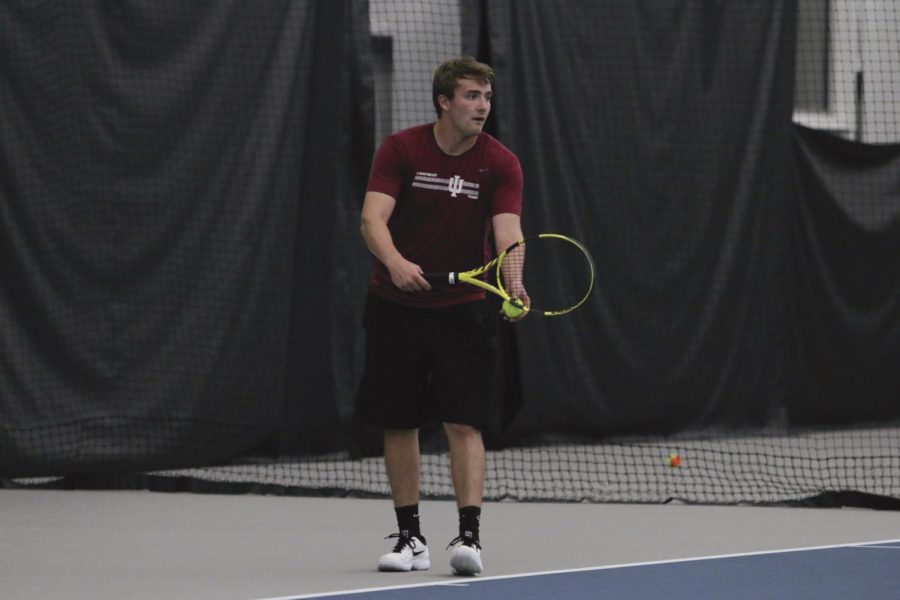Brock Winchell prepares to serve during a match against Asbury University on April 11, 2019.