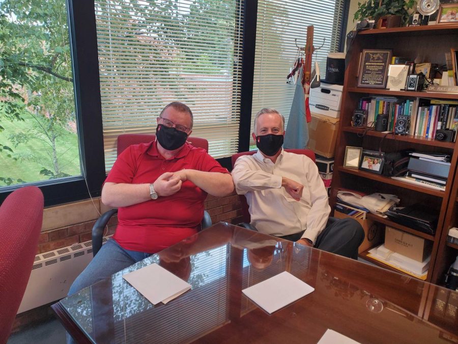 Chancellor Ray Wallace (left) and Vice Chancellor for Administrative Affairs Dana Wavle share an elbow bump during their discussion of IU retiring President Michael McRobbie's legacy.