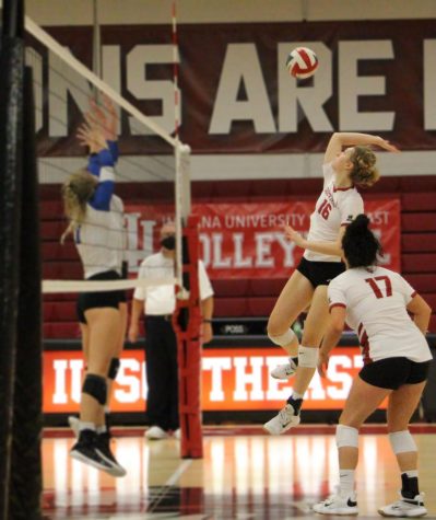 Junior Jennie Malone rears back to kill off an assist by Hannah Sipe (17) in the second set against RSC rival Brescia.