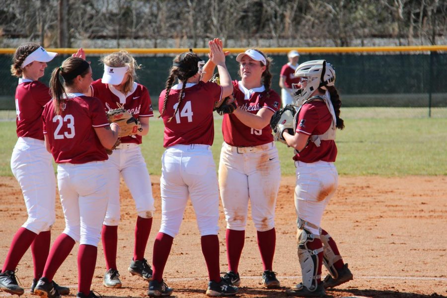 From left to right; Ellie Jackman, Madeline Probus (23), Lindsey Nelson, Brooklyn Gibbs (14), Kelsey Warman, and Reecie Gilliam all share a conversation in the pitcher's circle between innings during a home doubleheader against Saint Mary-of-the-Woods College on March 4, 2020.