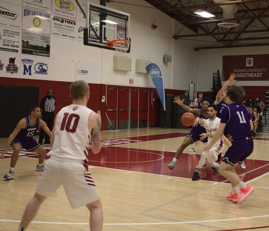 After drawing three Asbury defenders towards him, John Kinnaird Jr. passes out to Jared Osborne (#10) for a wide-open three-point attempt against the Eagles on Feb. 6.
