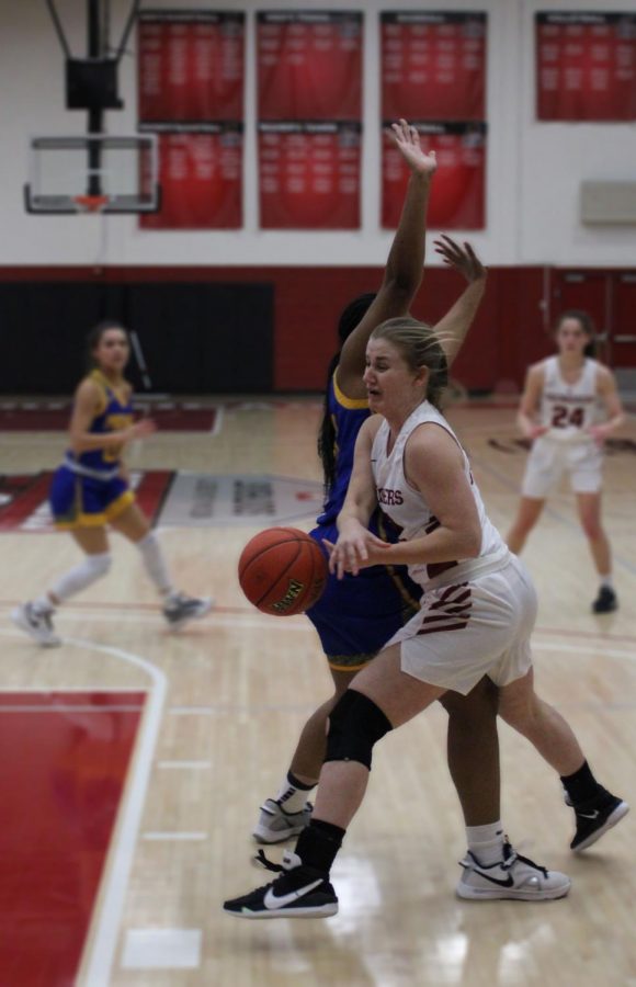 Freshman+guard+Leah+Miller+gets+a+body+check+from+Midways+TaTayana+Outlaw%2C+drawing+a+foul+in+the+process+during+the+Grenadiers+season+finale+on+Feb.+20.