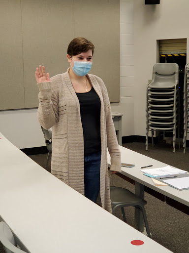 Rebecca Von Allmen raises her right hand as she is sworn into office as the new SGA President during a meeting on Feb. 19. Von Allmen previously served as vice president under her predecessor, Kameo Costello, who was removed shortly before Von Allmen was sworn in.