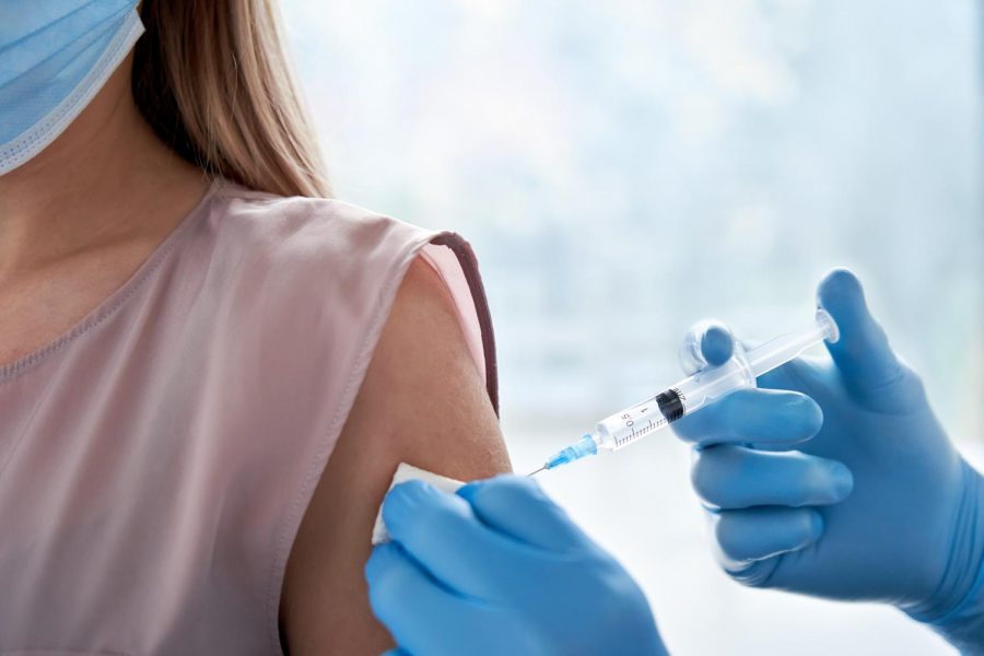 A young woman receives her COVID-19 vaccine. Photo: Adobe Stock