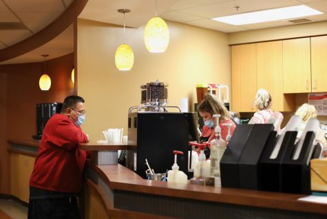 University Grounds barista Kati Curry makes a Starbucks drink for an IUS customer.