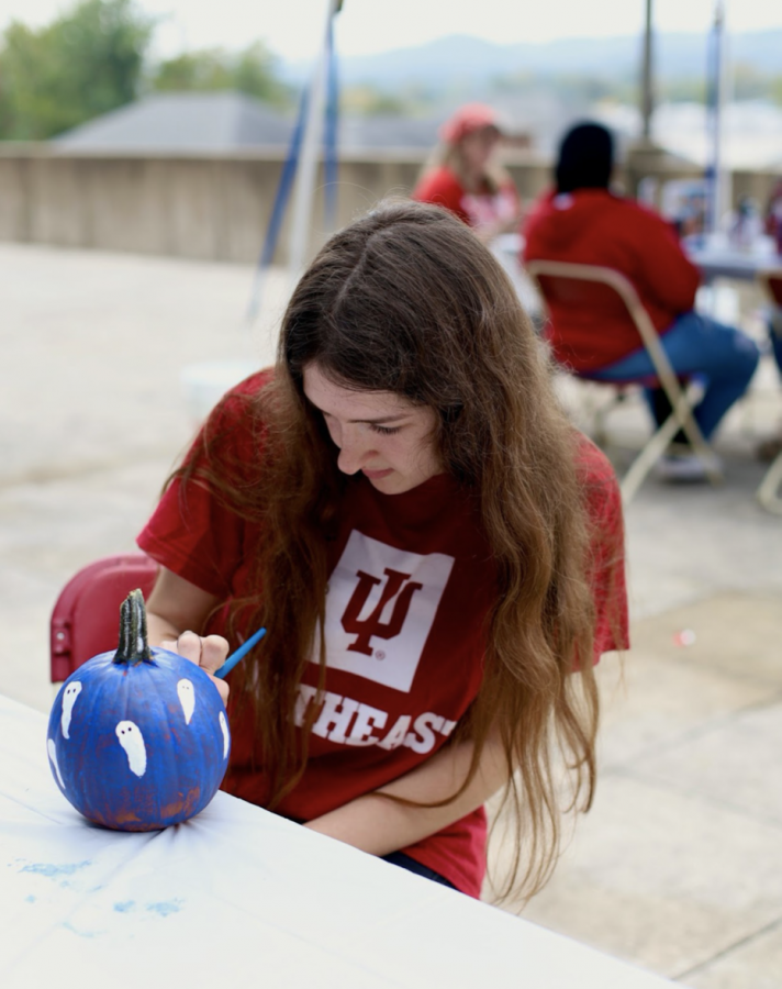 Rayna Kelley takes time between classes at IUS to paint a ghost pumpkin.